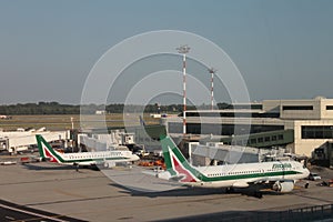 Milan, Italy - aug 2019: Two Alitalia airplanes docking at Malpensa International Airport.