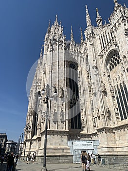 Milan, Italy - August 24, 2022: Partial side view of the facade of the Milan Cathedral Duomo