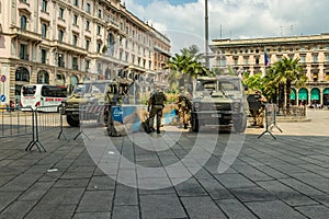 MILAN, ITALY - AUGUST 1, 2019 : Piazza del Duomo - Cathedral Square, entrance from Via Torino. Two military jeeps and guard