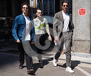 MILAN, ITALY -JUNE 16, 2018: Fashionable men walking in the street before MARNI fashion show, during Milan Fa