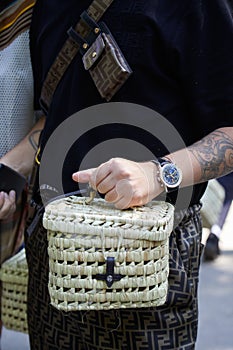 Man with Breitling watch and wicker bag before Fendi fashion show, Milan Fashion Week street style