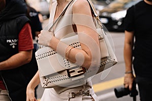 Milan, Italy - September 20, 2023: fashioner wearing maxi Baguette Fendi bag. Fashion blogger outfit details photo