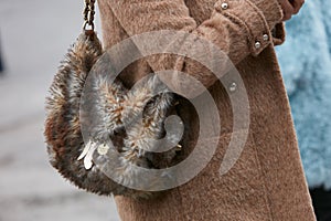 Woman with brown fur Patrizia Pepe bag before Pal Zileri fashion show, Milan Fashion Week street style on