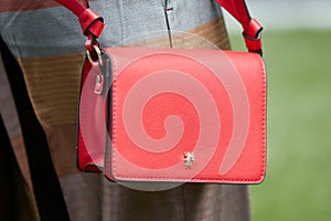 Woman with red Patrizia Pepe leather bag before Giorgio Armani fashion show, Milan Fashion Week street style