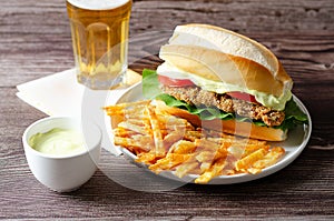 Milanesa sandwich with fries and beer