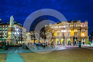 MILANO, ITALY, MARCH 13, 2016: night view of the illuminated teatro alla scala and statue of leonardo da vinci in the