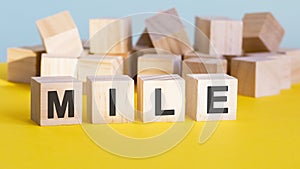 mile word construction with letter blocks and a shallow depth of field