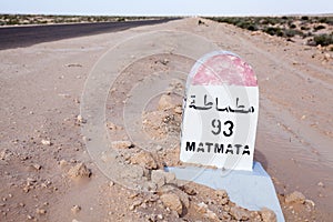 Milepost on a desert asphalt road to the Matmata destination, Tunisia, Africa. Road passing through the salt lake Chott El Djerid