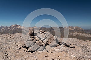 Milestones atop the 3144m Taillon Peak with Vignemale Peak in the background
