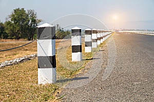 Milestones, black and white milestones with green grass roadside,