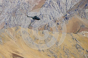 Militari helicopter flying in mountains