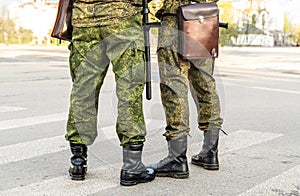 Militaries legs with security truncheons and officers bag.