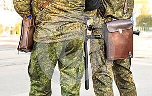 Militaries legs with security truncheons and officers bag.