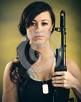 Militarized Young Woman WIth Assault Rifle