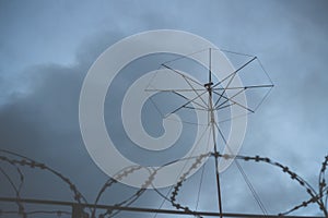 Military antenna. Radio electronic troops. Guarded object, barbed wire fence