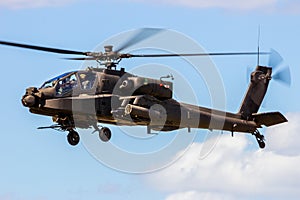 military Apache attack helicopter hovering