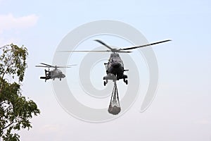 Military Apache is guiding a Cougar transport heli