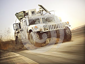 Military armored vehicle moving at a high rate of speed with motion blur over sand. Generic