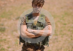 Military, arms crossed and portrait of man in nature for war, conflict and patriotism. Army, surveillance and security