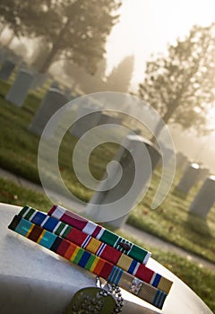 Military Award Ribbons and Dog Tags on Veteran Tombstone