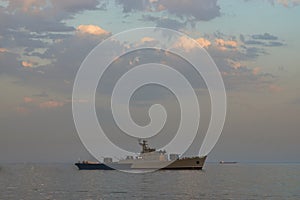 Military Battleships in a sea bay at sunset time