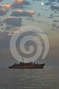 Military Battleships in a sea bay at sunset time