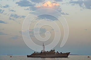 Military Battleships in a sea bay at sunset time