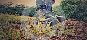 Military boots on ground on a sunny day