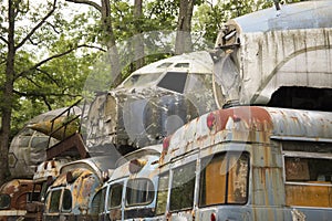 Military buses piled with aircraft in junkyard