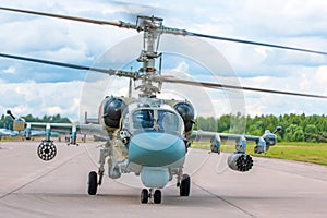 Military combat helicopter taxiing makes a turn in the airfield