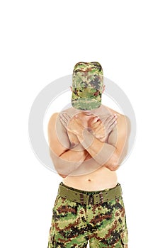 Military combatant officer praying with arms crossed and head bo photo