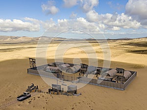 Military compound in the middle east, aerial view of a military base. Guard towers and reinforced concrete fence