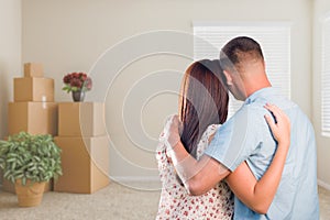 Military Couple Facing Empty Room with Packed Moving and Potted