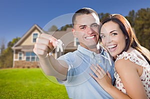 Military Couple with House Keys In Front of New Home