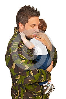 Military dad hugging his newborn baby