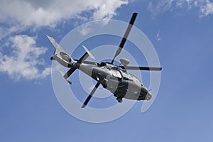 Military dauphin helicopter flying in the air