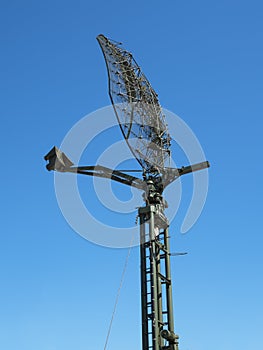 Military directional antenna on a blue sky.