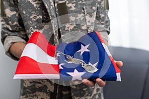 Military dog tags on american flag.