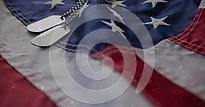 Military dog tags over american flag background with copy space