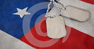 Military dog tags over american flag background with copy space