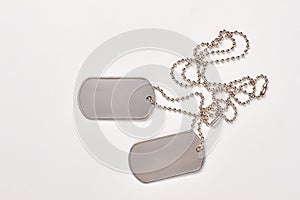 Military dog tags on white background.