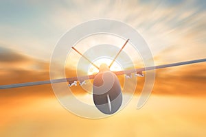 Military drone flight motion blur on sunset background. Close up view