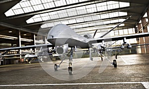 Military Drone UAV aircraft`s with ordinance in position in a hangar awaiting a strike mission.