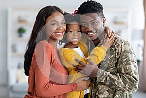 Military Family. Portrait Of African American Male Soldier With Wife And Daughter