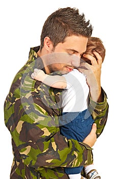 Military father embracing his baby son