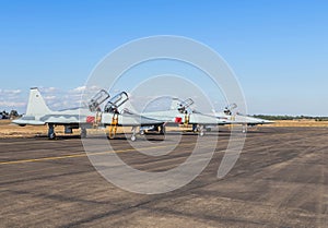 Military fighter jet aircrafts parked on runway in airforce base