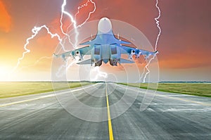 Military fighter jet flies taxiway at the airport. Lightning strike on sunset thunderstorm.
