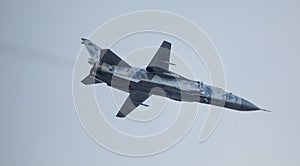 Military fighter plane with variable sweep wing on sky background
