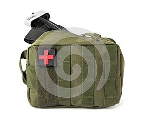 Military first aid kit and tourniquet on white background