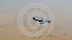 Military freighter plane over Middle East desert 4K